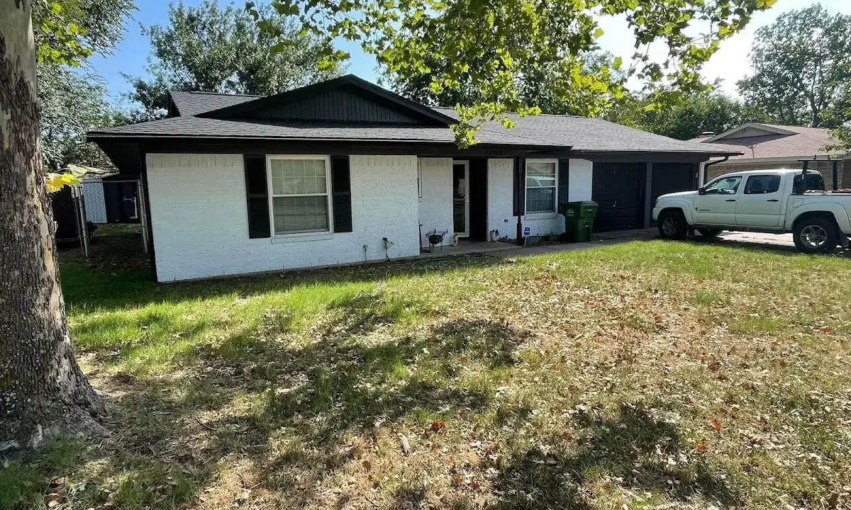 Professional roofing crew working on a residential roof in Kaufman